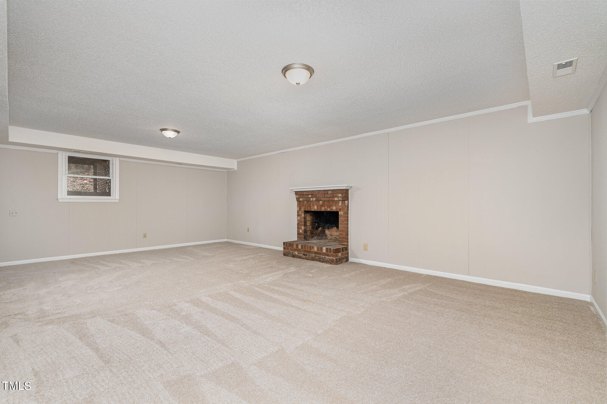 3703 Sandy Ridge Lane Durham, NC 27705 - Photo 28 of 36 a view of an empty room with a fireplace