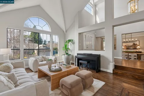 a living room with furniture a fireplace and a floor to ceiling window