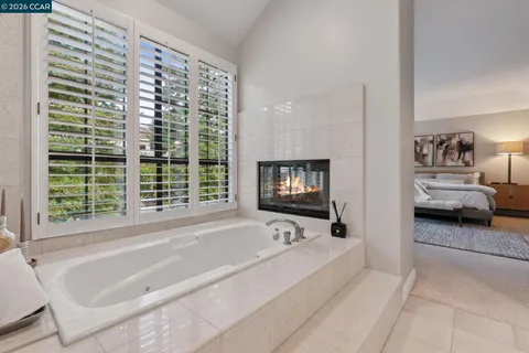 a spacious bathroom with bathtub and a large window