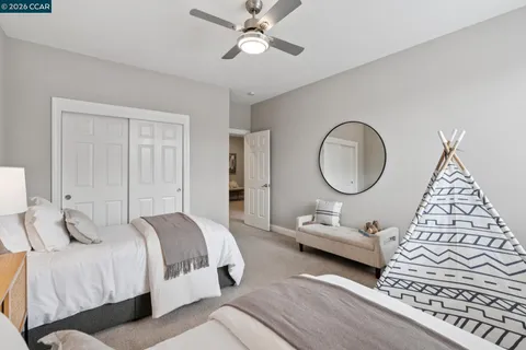 a bedroom with a large bed and a chandelier