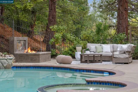 a view of a swimming pool with furniture