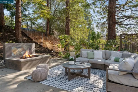 a view of a patio with couches and a fire pit