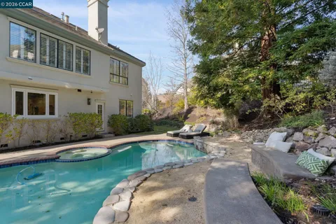 a view of a house with backyard and sitting area