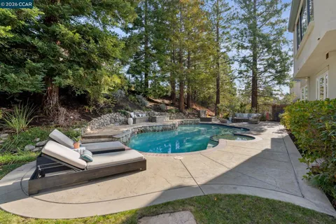 a view of a house with backyard and sitting area