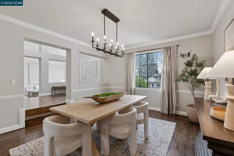a kitchen with a table chairs stove and kitchen view