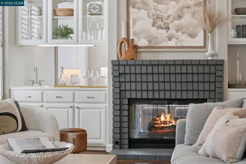 a living room with furniture a fireplace and decor