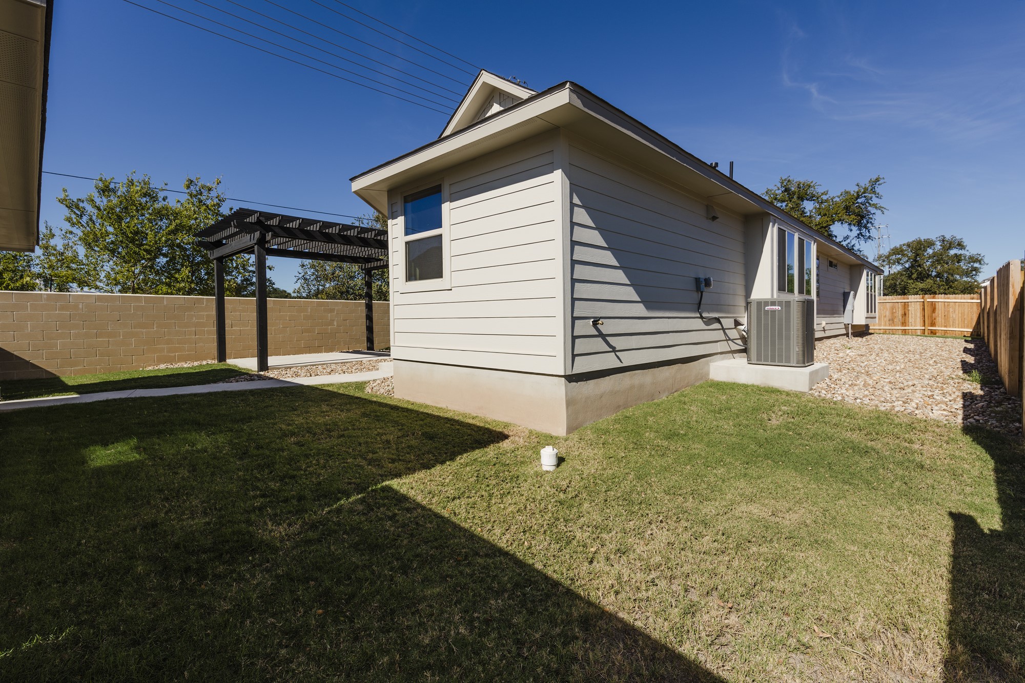 2725 Hopi Path Leander, TX 78641 - Photo 6 of 30 A private backyard featuring a pergola and a well-maintained lawn.