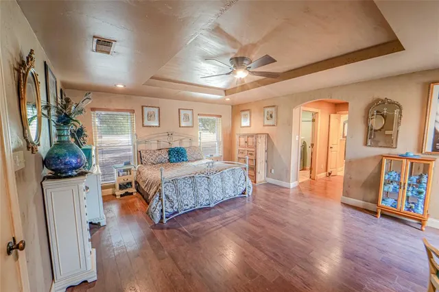 a bedroom with furniture and a wooden floor