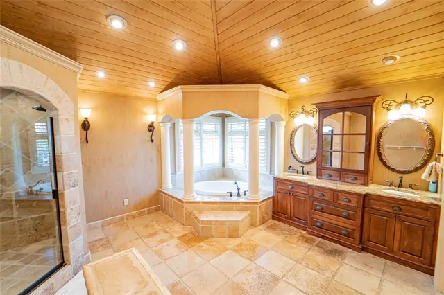 a view of a bathroom with a tub shower and mirror