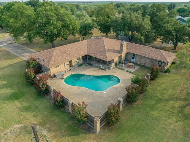 an aerial view of a house with outdoor space patio and yard