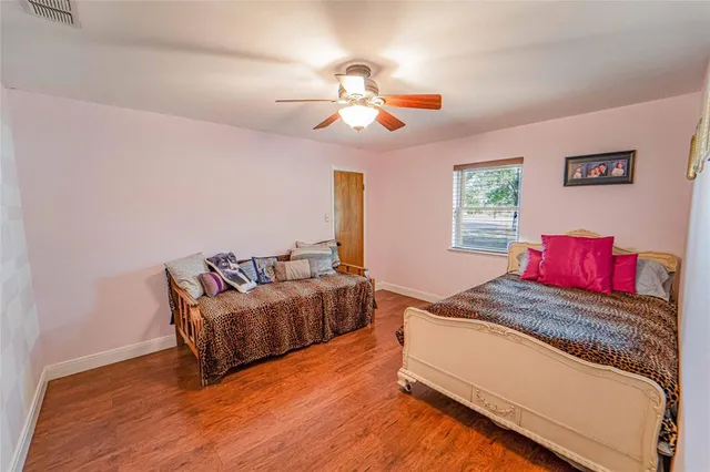 a bathroom with a granite countertop sink a mirror and shower