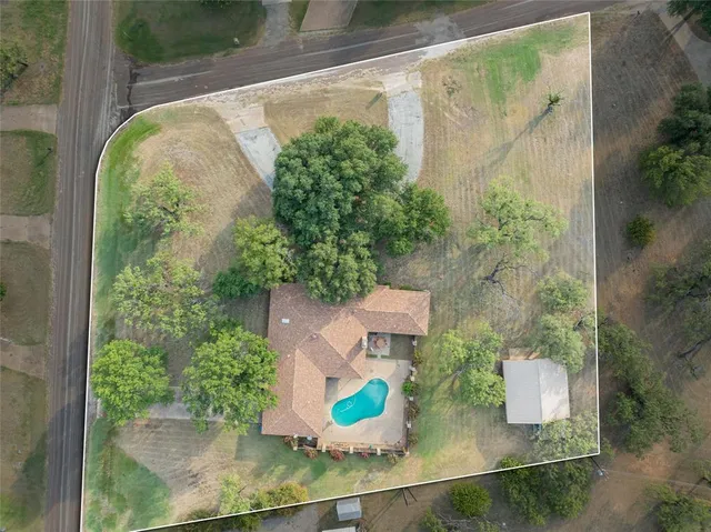 an aerial view of a house with a yard