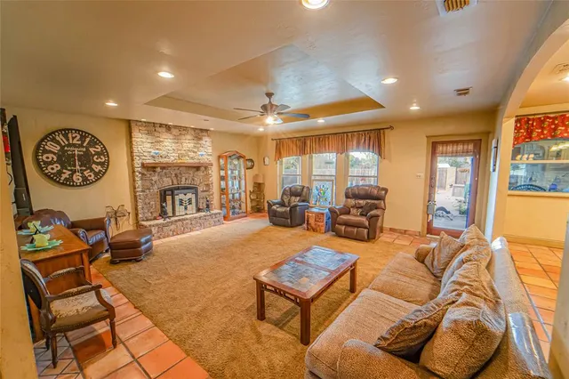 a living room with furniture a large window and gym equipment