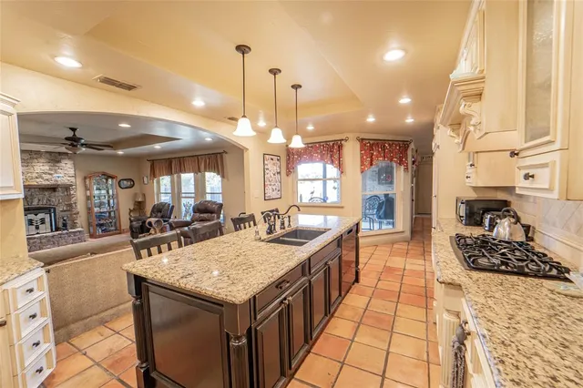 a kitchen with a stove kitchen island and chairs