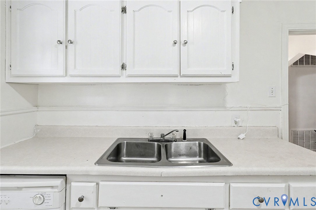 129 Seaboard Street Petersburg, VA 23803 - Photo 8 of 21 a kitchen with white cabinets and a white refrigerator