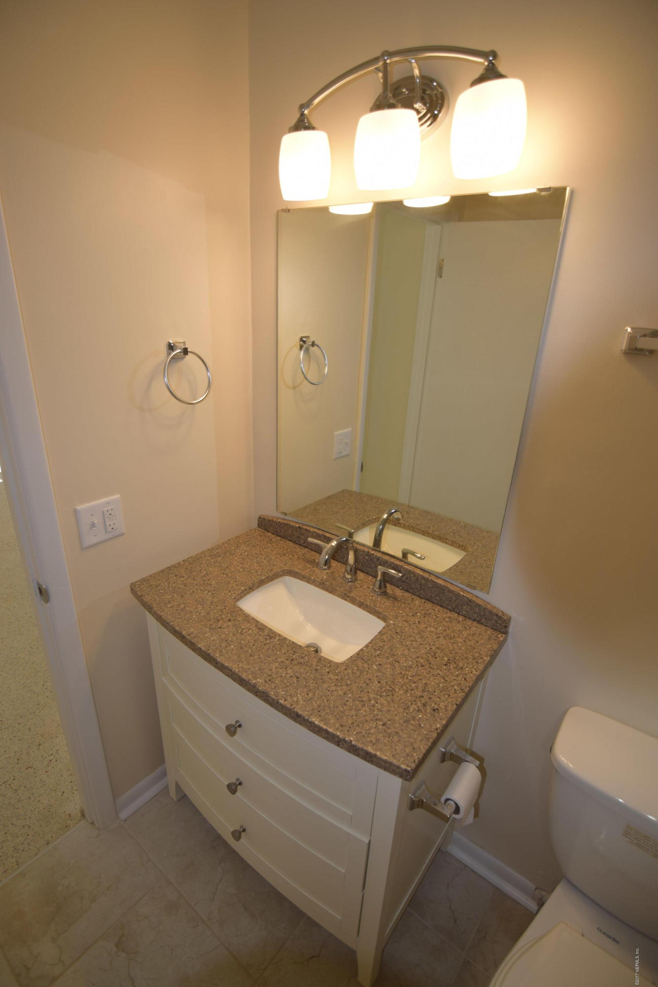 1904 Ector Road Jacksonville, FL 32211 - Photo 9 of 48 a bathroom with a granite countertop sink and a mirror