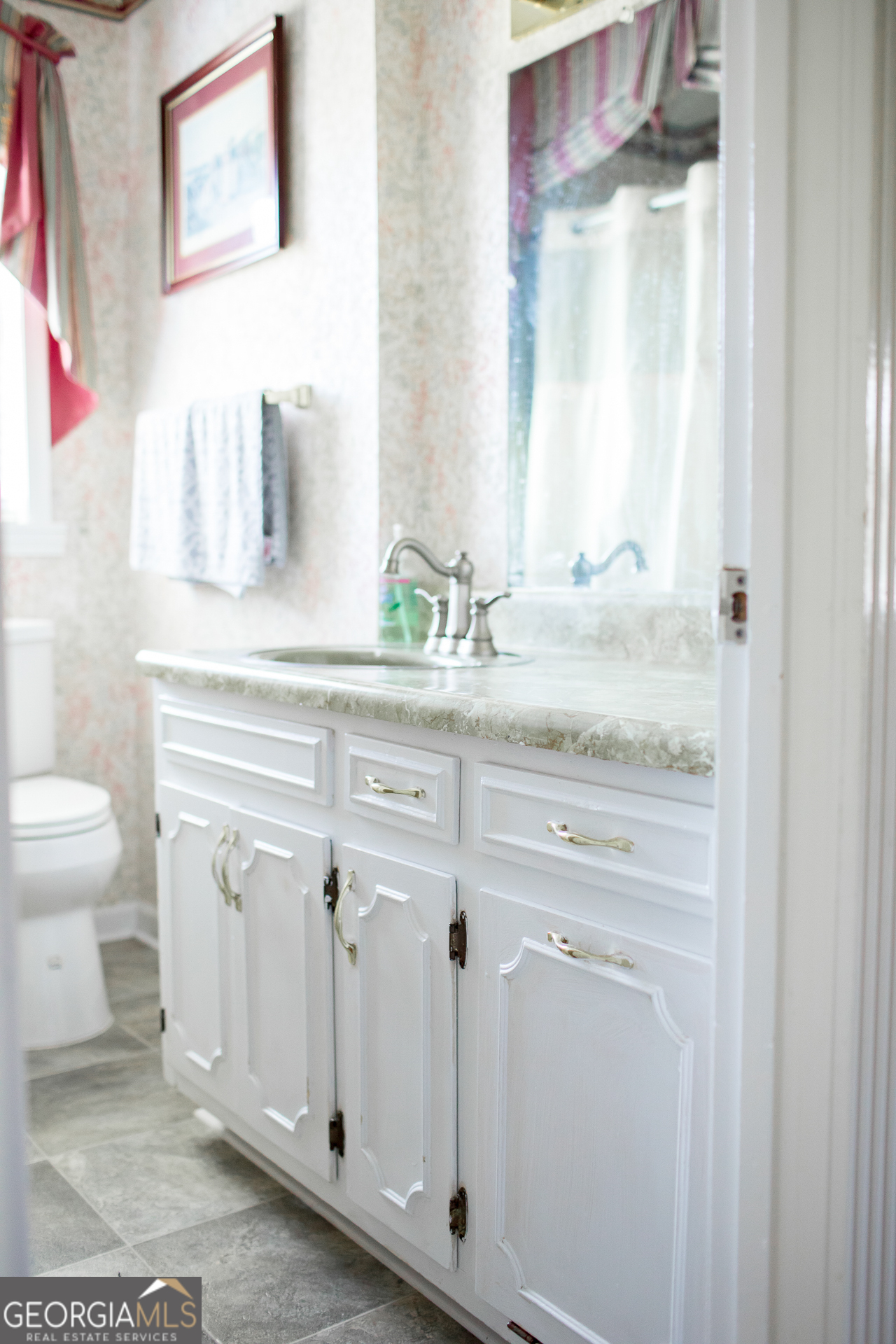 2110 Ware Street Blackshear, GA 31516 - Photo 43 of 57 a bathroom with a sink a toilet and a mirror