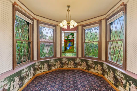 a kitchen with stainless steel appliances granite countertop refrigerator a sink dishwasher a stove top oven and a dining table with wooden floor