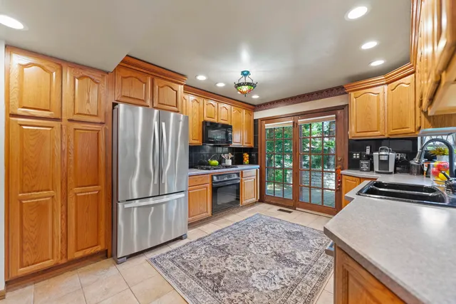 a bathroom with a granite countertop sink and a bathtub