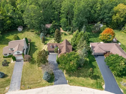 an aerial view of house with yard swimming pool and outdoor seating