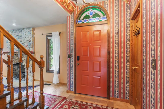 an empty room with wooden floor and ceiling fan