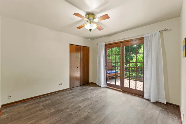 a spacious bedroom with a bed and a chandelier