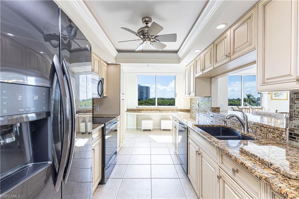 25 Bluebill Avenue, Unit 301 Naples, FL 34108 - Photo 13 of 41 a kitchen with stainless steel appliances granite countertop a sink and a stove
