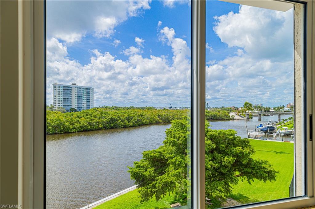 25 Bluebill Avenue, Unit 301 Naples, FL 34108 - Photo 18 of 41 a view of a lake from a window