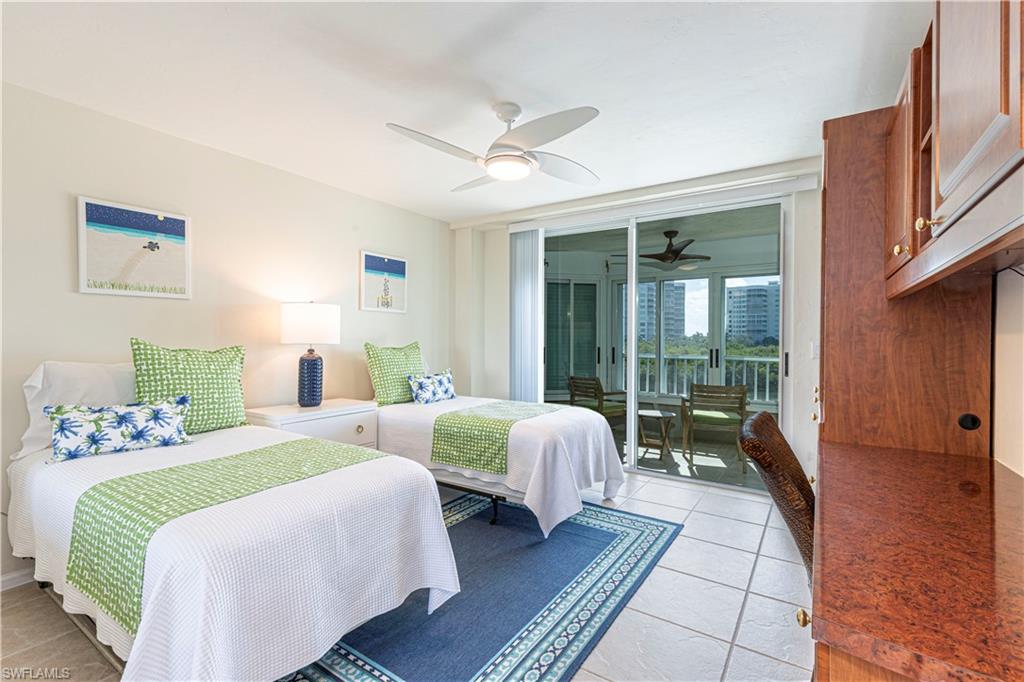 25 Bluebill Avenue, Unit 301 Naples, FL 34108 - Photo 20 of 41 a spacious bedroom with two beds and a large window