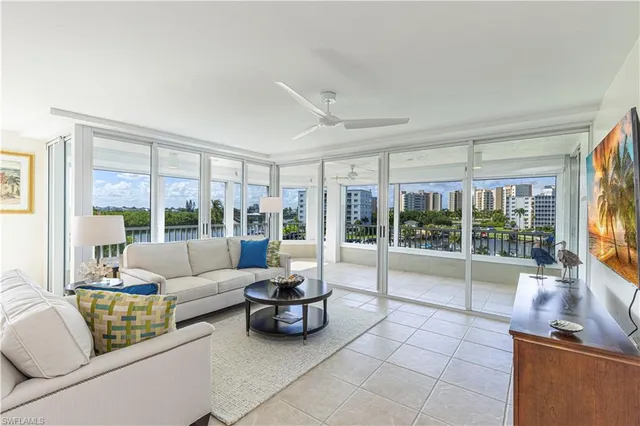 a living room with furniture and a floor to ceiling window