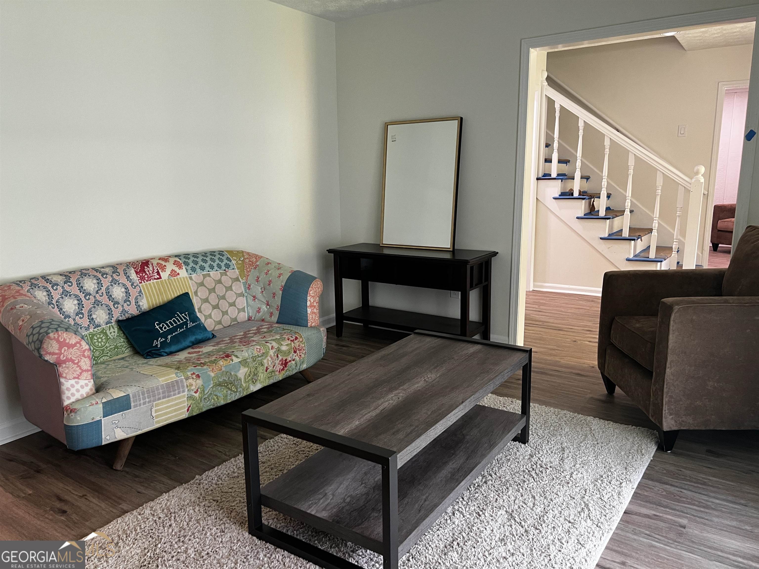 208 Swanson Ridge Peachtree City, GA 30269 - Photo 21 of 40 a living room with furniture and a wooden floor