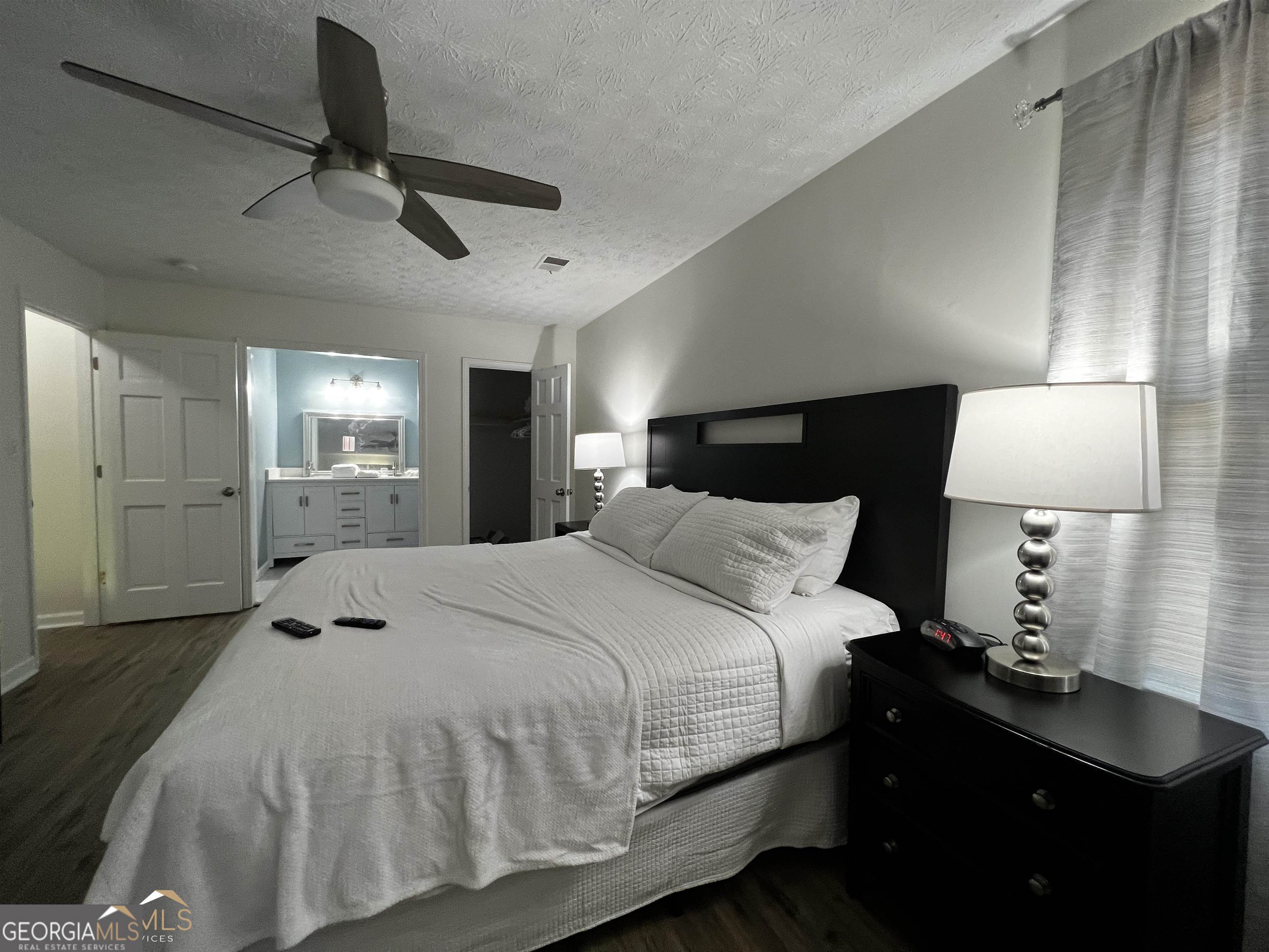 208 Swanson Ridge Peachtree City, GA 30269 - Photo 29 of 40 a bedroom with a bed and a lamp on dresser