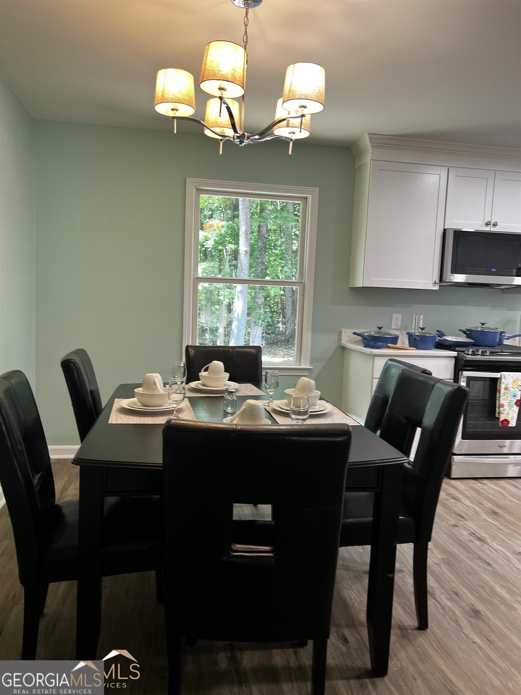 208 Swanson Ridge Peachtree City, GA 30269 - Photo 6 of 40 a view of a dining room with furniture a chandelier and wooden floor