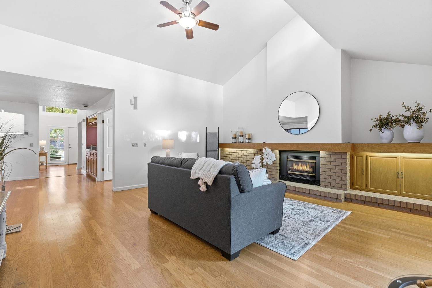 1833 Edgebrook Drive, Unit A Modesto, CA 95354 - Photo 13 of 43 a living room with couches and kitchen view with wooden floor
