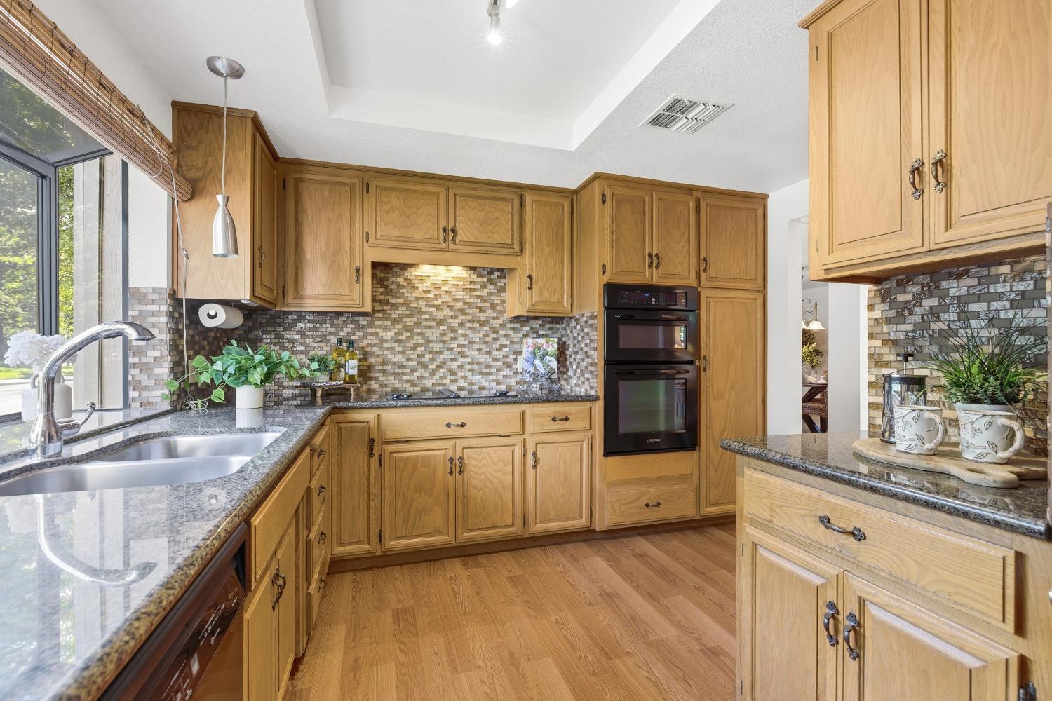 1833 Edgebrook Drive, Unit A Modesto, CA 95354 - Photo 18 of 43 a kitchen with stainless steel appliances granite countertop a sink and wooden cabinets
