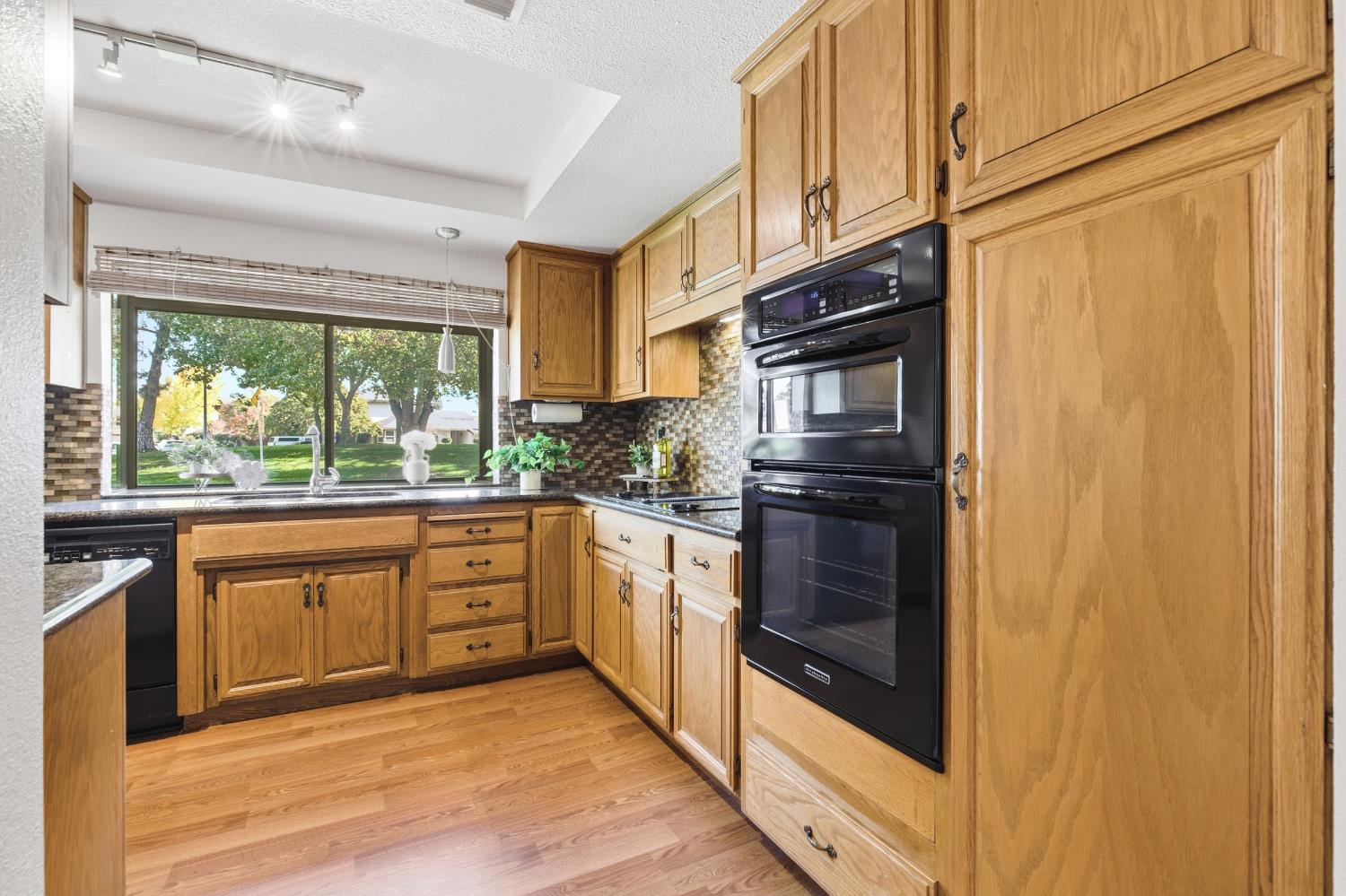 1833 Edgebrook Drive, Unit A Modesto, CA 95354 - Photo 19 of 43 a kitchen with stainless steel appliances granite countertop a stove and a refrigerator