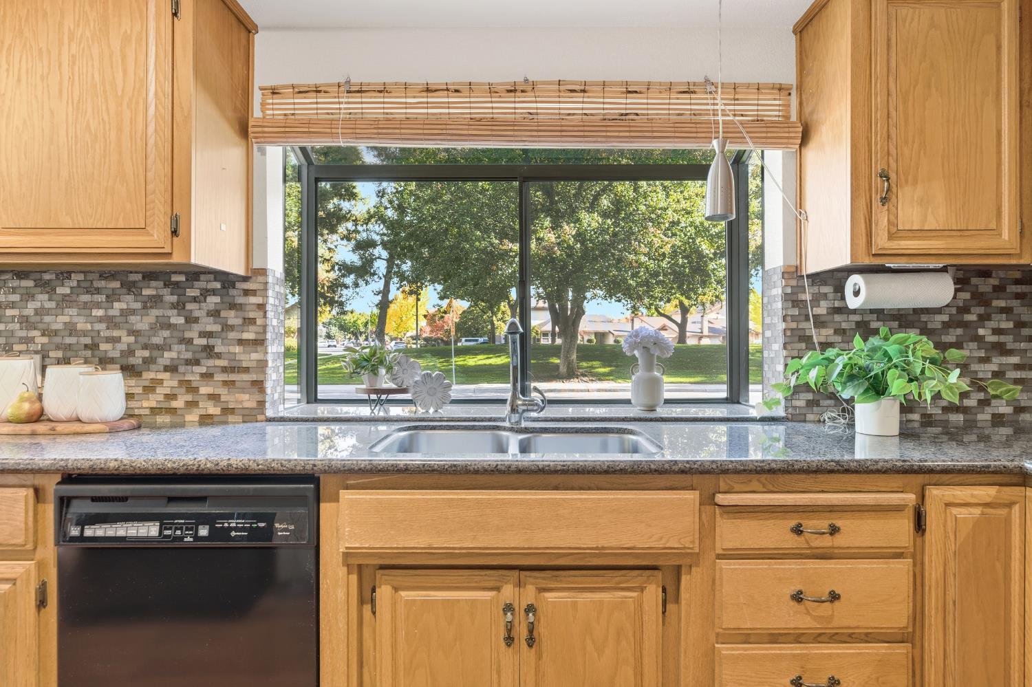1833 Edgebrook Drive, Unit A Modesto, CA 95354 - Photo 21 of 43 a kitchen with granite countertop white cabinets and a window