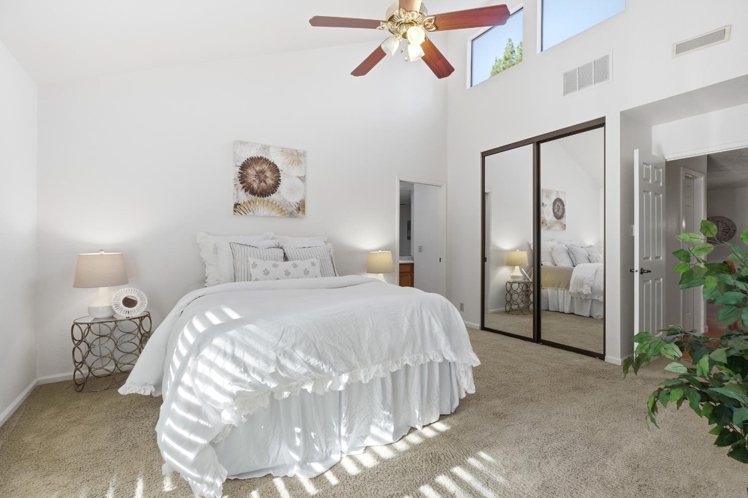 1833 Edgebrook Drive, Unit A Modesto, CA 95354 - Photo 26 of 43 a bedroom with a bed and a chandelier