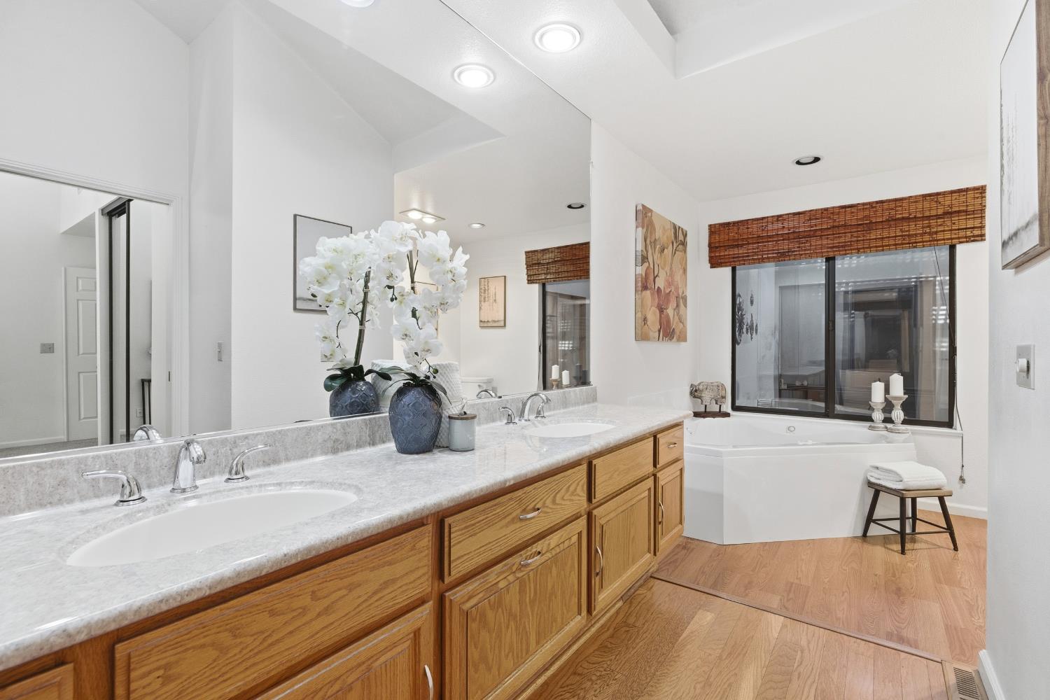 1833 Edgebrook Drive, Unit A Modesto, CA 95354 - Photo 27 of 43 a large bathroom with double vanity sinks a large mirror and a shower