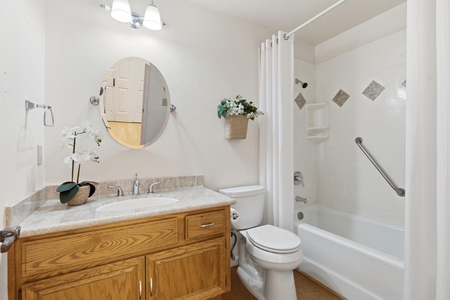 1833 Edgebrook Drive, Unit A Modesto, CA 95354 - Photo 32 of 43 a bathroom with a granite countertop sink a toilet and a mirror
