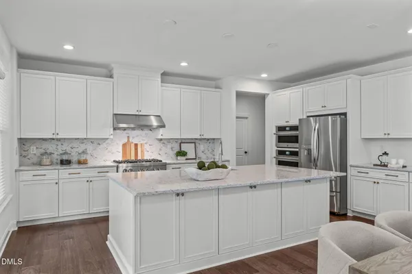 a spacious bedroom with a bed and a window