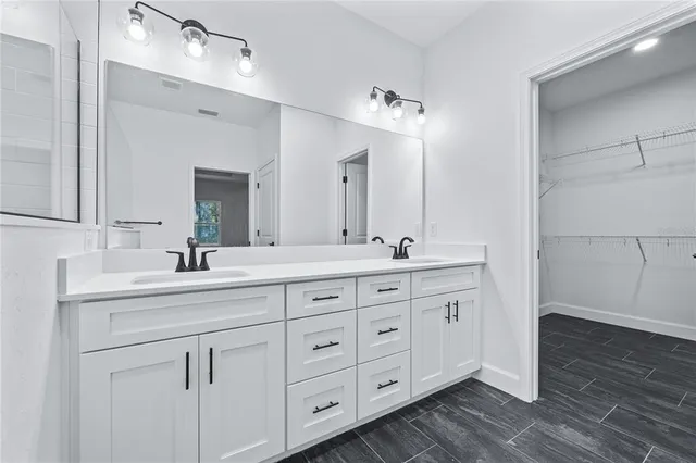 a bathroom with double sink and a mirror