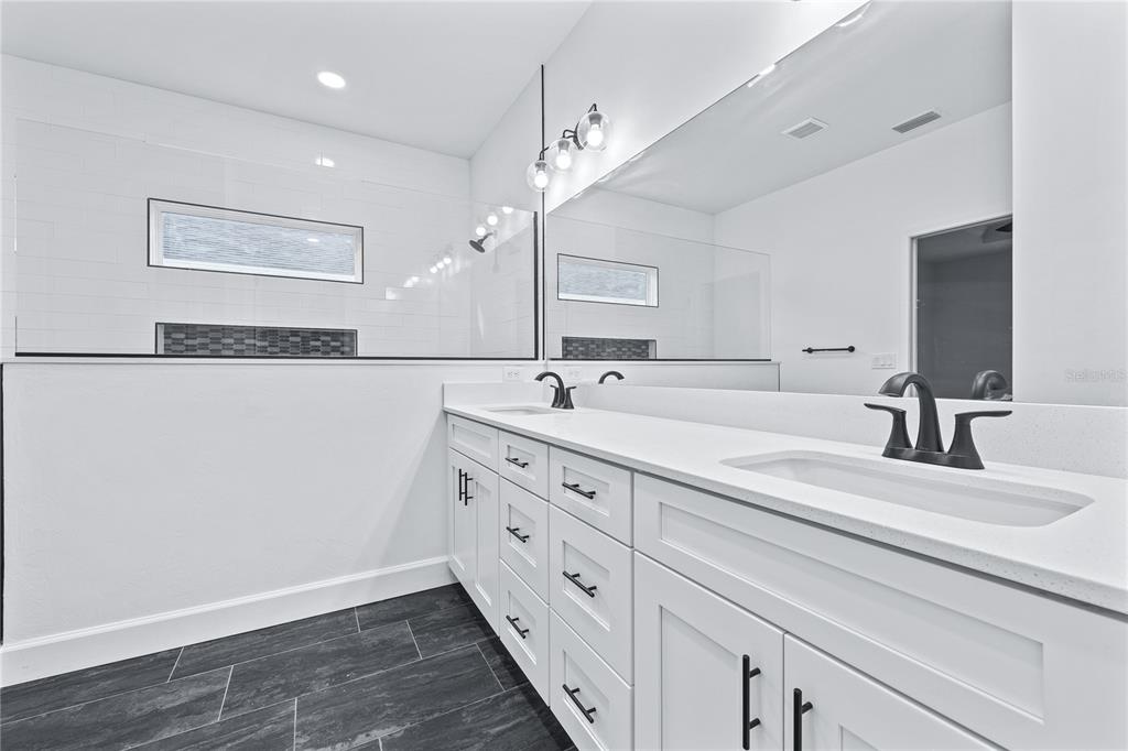 6682 Southwest 10th Lane Gainesville, FL 32607 - Photo 12 of 28 a spacious bathroom with a double vanity sink and a mirror