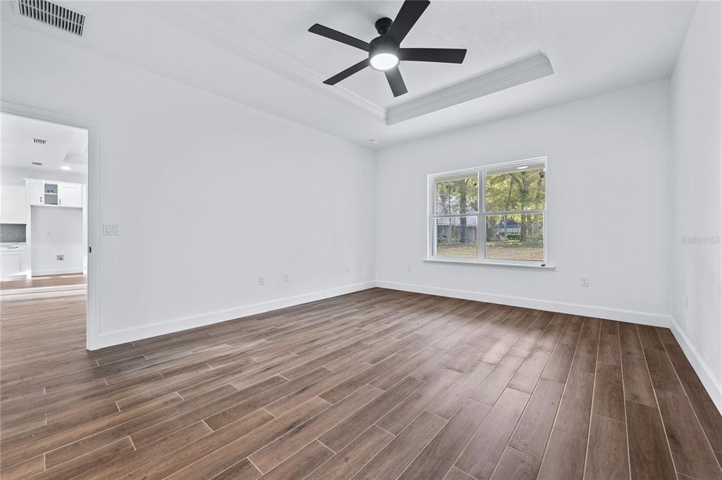 6682 Southwest 10th Lane Gainesville, FL 32607 - Photo 13 of 28 an empty room with wooden floor and windows