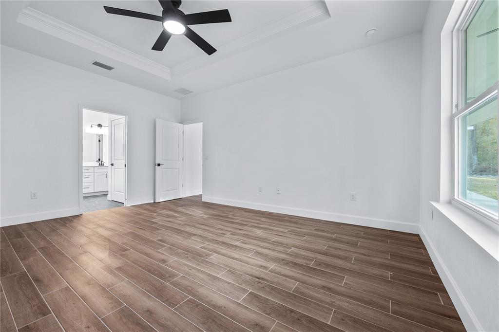 6682 Southwest 10th Lane Gainesville, FL 32607 - Photo 14 of 28 wooden floor in an empty room with a window