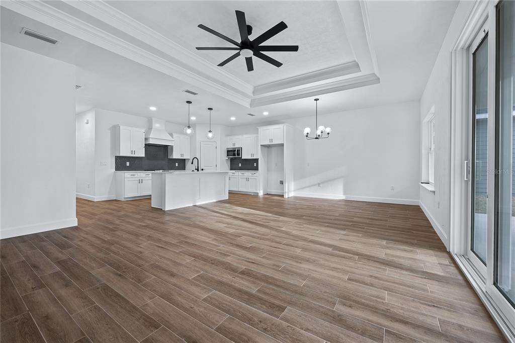 6682 Southwest 10th Lane Gainesville, FL 32607 - Photo 16 of 28 a view of kitchen and empty room with wooden floor