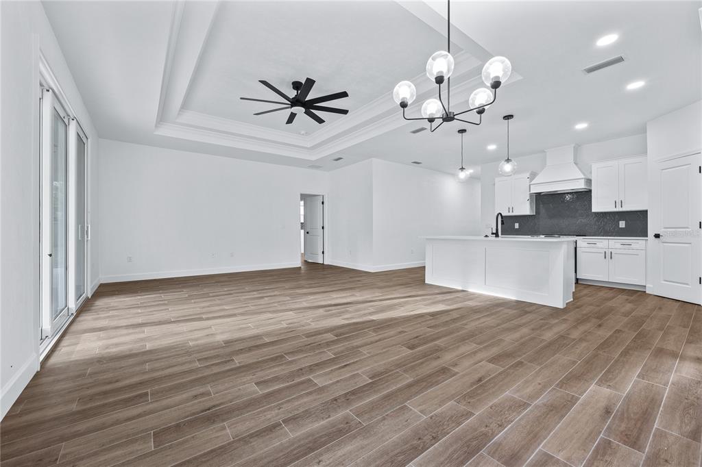 6682 Southwest 10th Lane Gainesville, FL 32607 - Photo 17 of 28 a view of a kitchen with an empty room and wooden floor