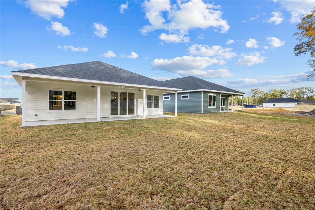 6682 Southwest 10th Lane Gainesville, FL 32607 - Photo 24 of 28 a house view with swimming pool and yard in front of it
