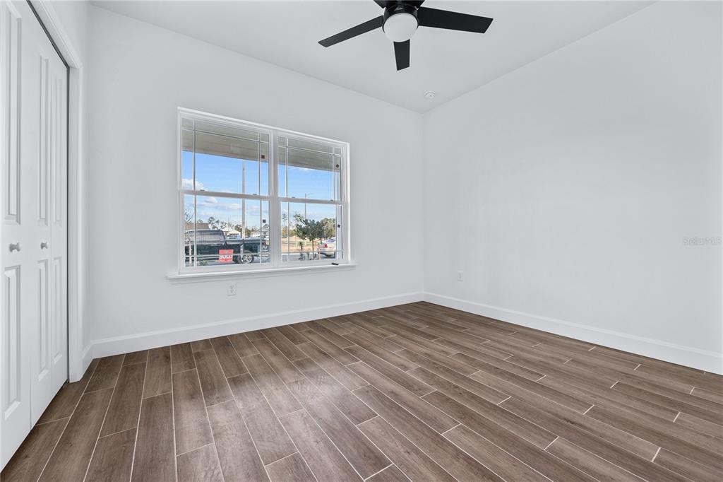 6682 Southwest 10th Lane Gainesville, FL 32607 - Photo 5 of 28 wooden floor in an empty room with a window