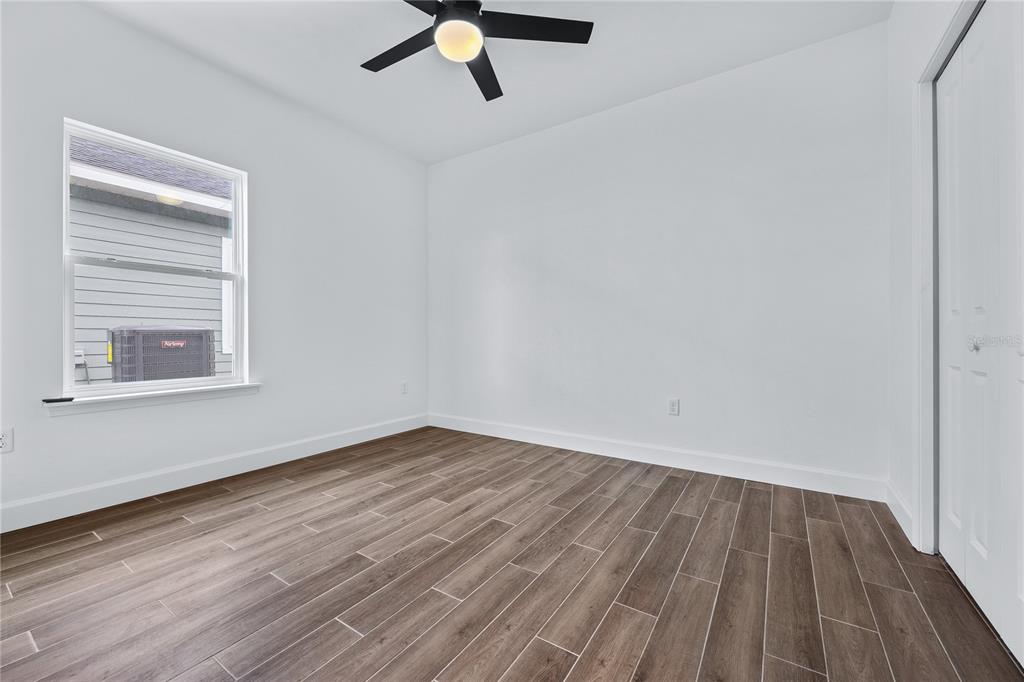 6682 Southwest 10th Lane Gainesville, FL 32607 - Photo 6 of 28 a view of an empty room with wooden floor and a window